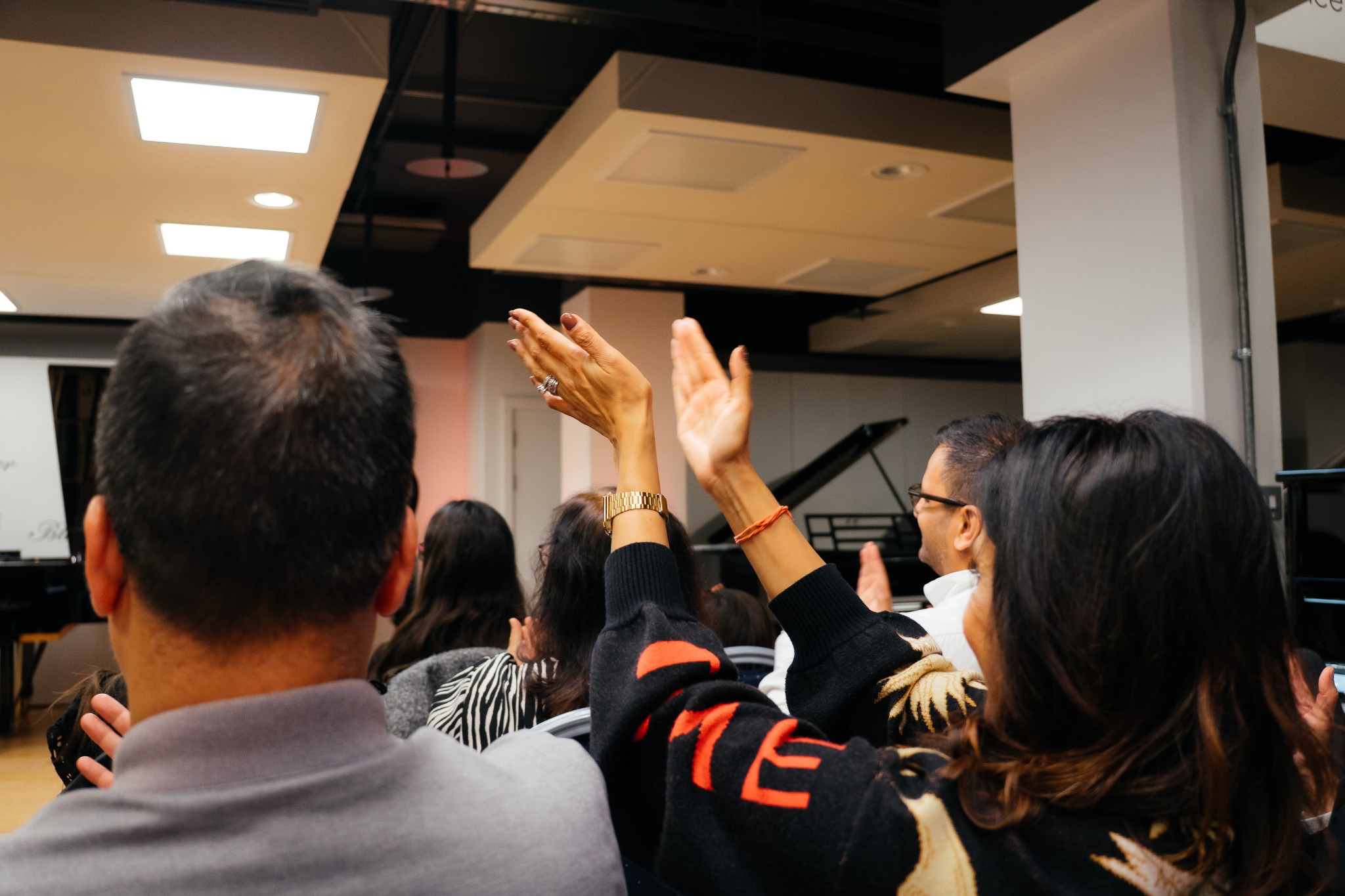 Audience applauding during a student piano concert at The London Piano Practice