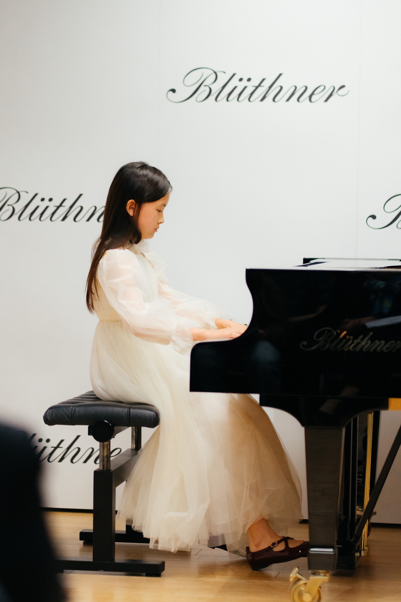Young pianist performing at Blüthner Piano Centre